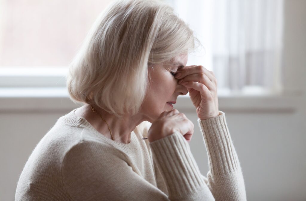 A person experiencing headaches from strabismus after getting cataract surgery.
